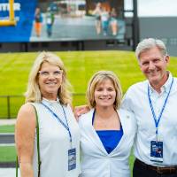 Randy Damstra posing with two guests at the Jamie Hosford Football Center dedication.